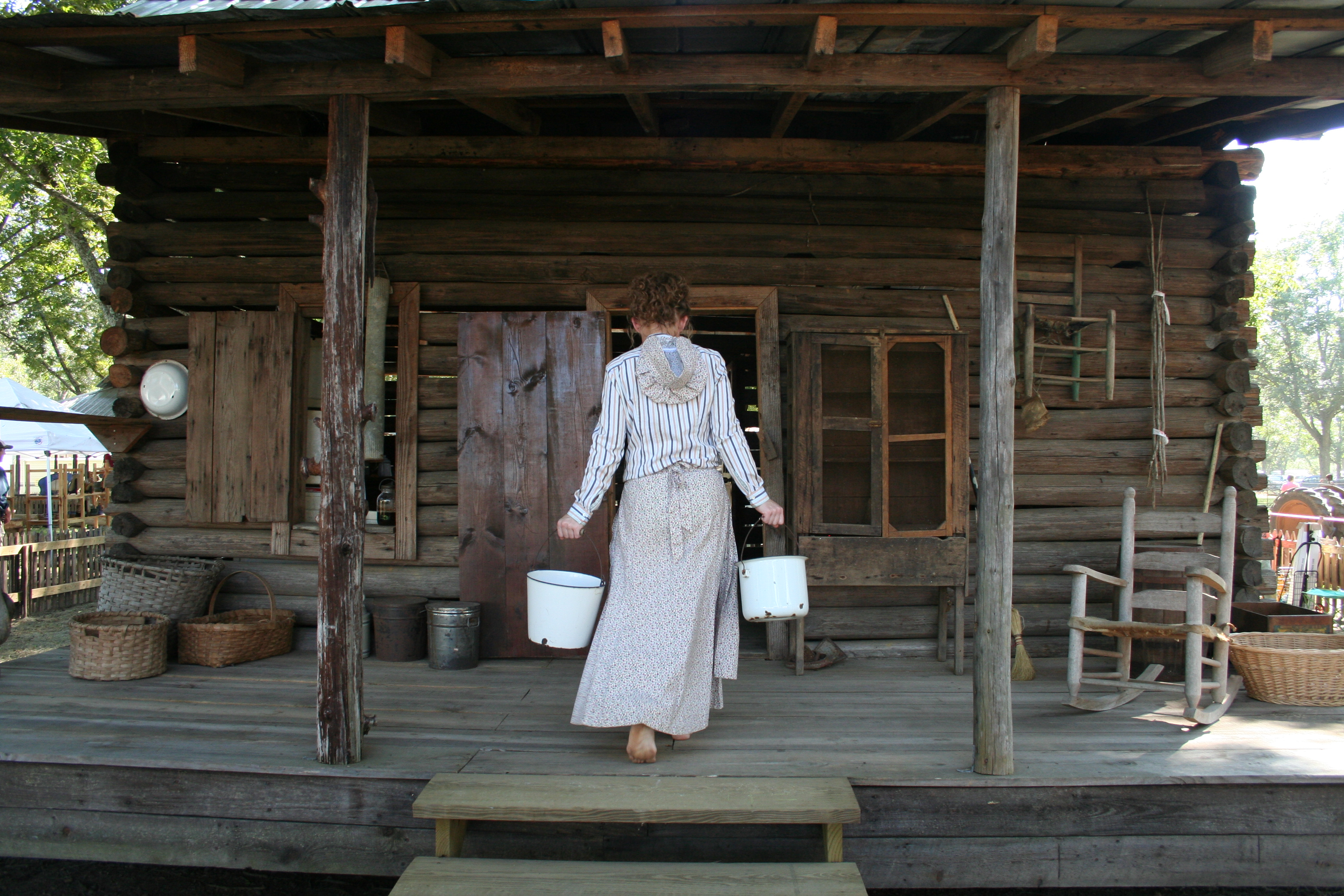 Pioneer homesteader at the log cabin